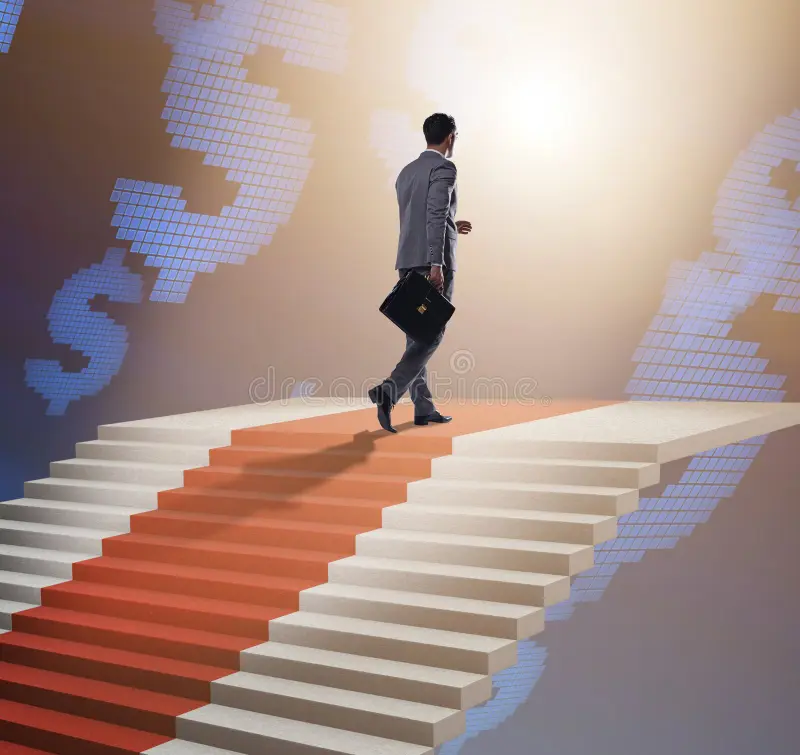 young-businessman-climbing-stairs-red-carpet-299283335